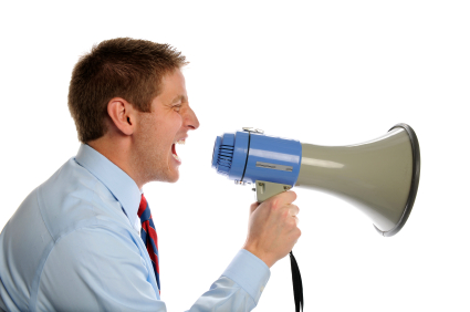 Young businessman using megaphone isolated over white background